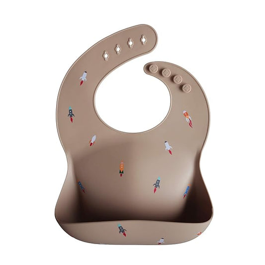 mushie Silicone Baby Bib | Adjustable Fit Waterproof Bibs (Rocket Ship)