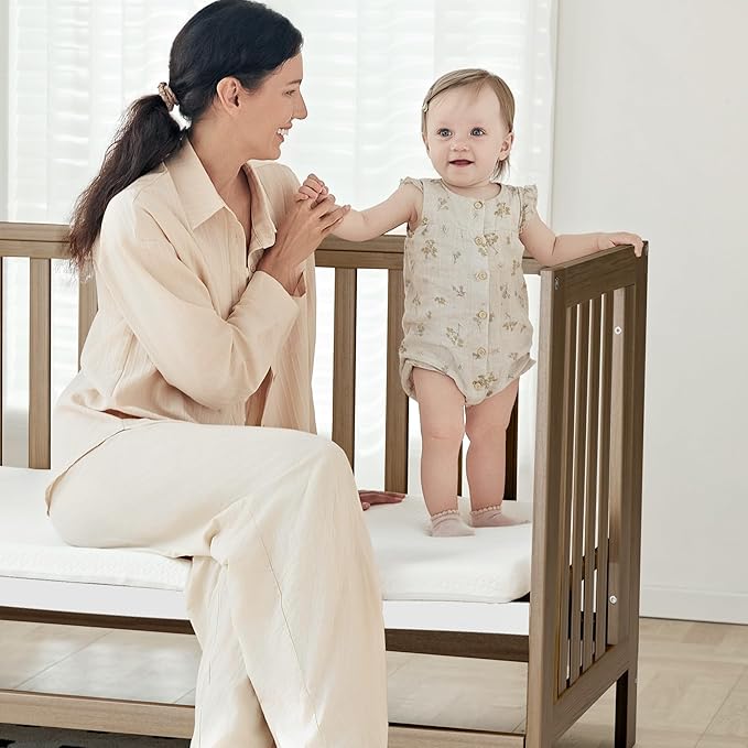 EvoNest Baby Crib, 11 in 1 Convertible Mini Crib with Wheels, 100% New Zealand Wood Growing Bed, 4 Adjustable Mattress Height ，Walnut Brown